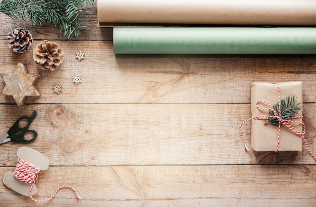 Wrapping Christmas presents in kraft paper minimial Christmas creative background with copy space