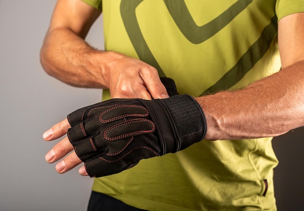 Wrapping putting on training workout sport gloves on hands for\
wrist protecting