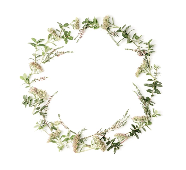 Photo wreath frame with pink flowers heath branches and leaves on white background flat lay style overhead view copy space