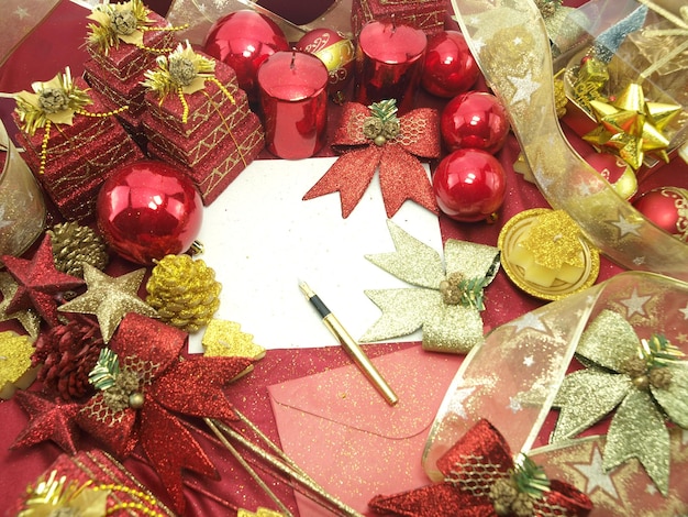 A wreath with ornaments and a white card with a gold ribbon.