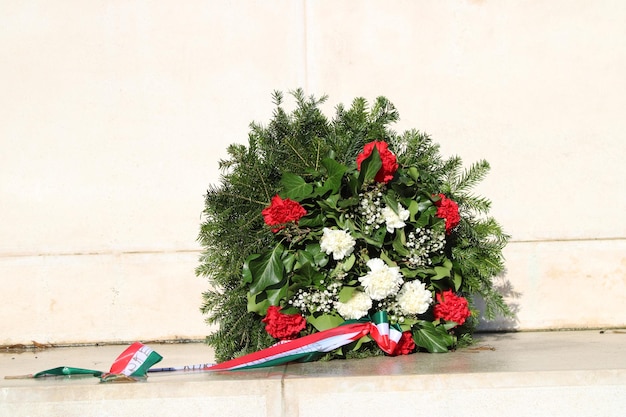 Photo wreath with red and white flowers and with hungarian flag strap