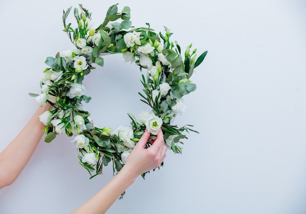 Wreath with white roses on white background. Decorated