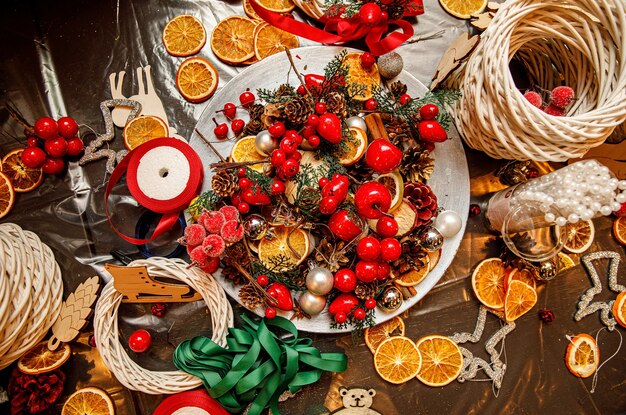 Wreaths, citrus fruits, cranberries, cones top view