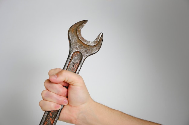 Wrench in hand gray background concept Labor Day first May