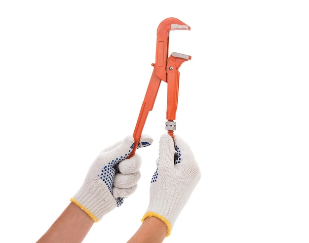 Photo wrench in hands with gloves isolated on a white background