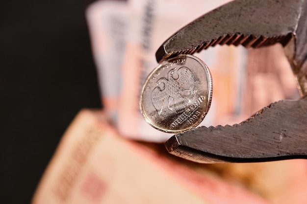 Wrench holds the Russian ruble The idea of the collapse of the ruble and economy sanctions against Russia economic crisis in Russia due to the war in Ukraine