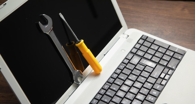 Wrench and screwdriver with a laptop computer IT Service Support