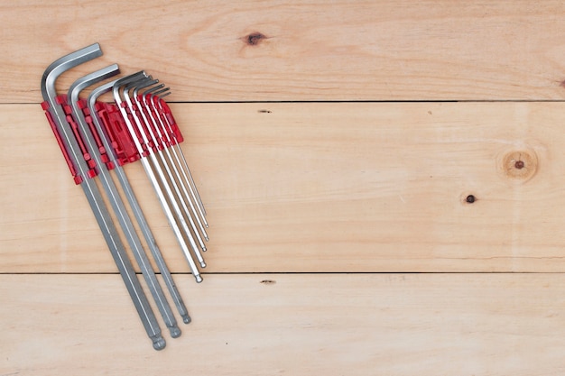 Wrench tool on wooden background.