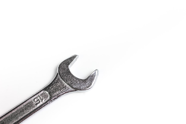 A wrench on a white background close-up. A hand tool for home repairs. The wrench head on a white background.