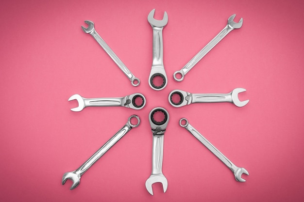 Wrenches tools on a pink background