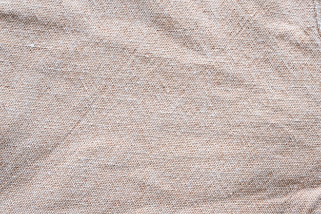 Wrinkled brown cotton fabric textured background