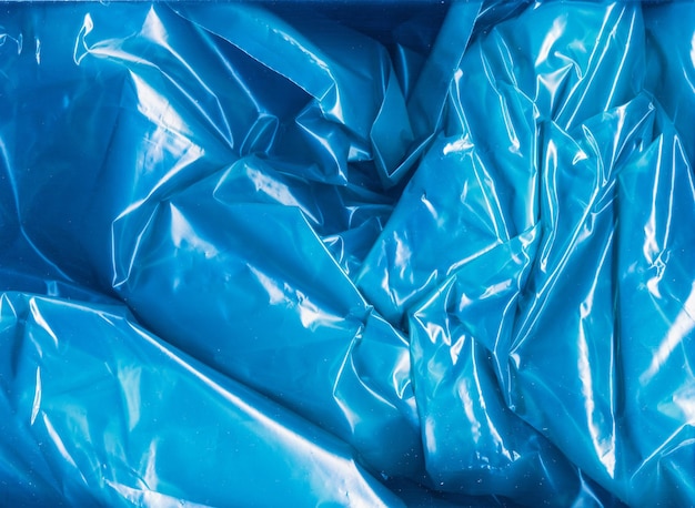 Wrinkled overlay Crumpled film texture Creased cellophane bag Ecology water pollution Blue distressed creased transparent shiny plastic bag abstract background