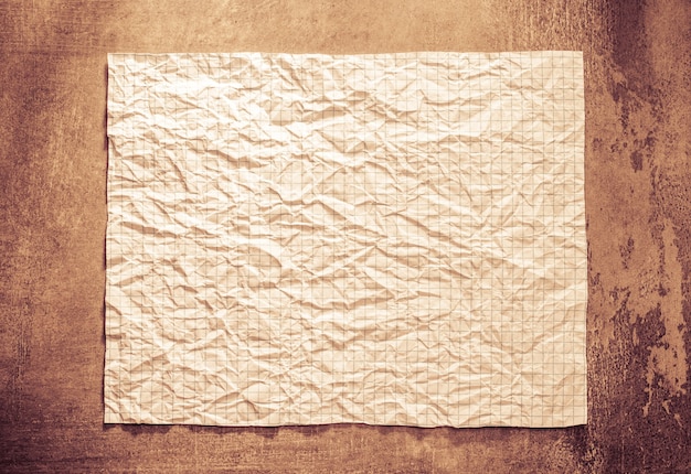 Wrinkled paper at wall background