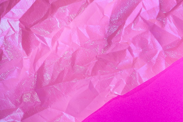 Wrinkled purple pink holographic crumpled paper abstract background