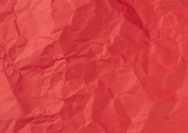 Wrinkled sheet of red paper Textured backdrop