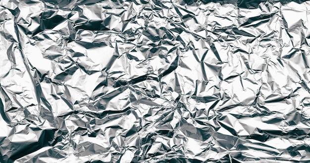 Wrinkled silver foil texture. Grunge metal background