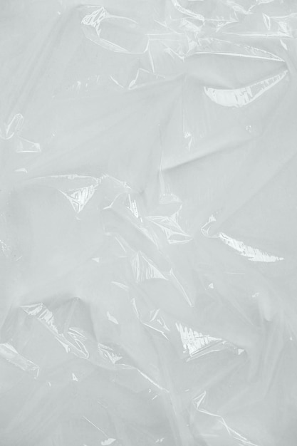 Wrinkled transparent plastic texture on a white background.\
transparent packaging film. top view. copy, empty space for\
text