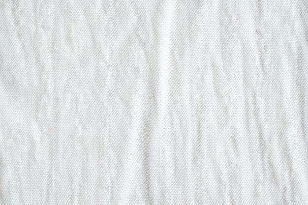 Photo wrinkled white cotton fabric texture background, wallpaper