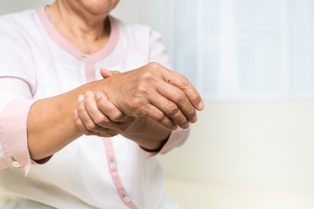 Wrist hand pain of old woman, healthcare problem of senior concept