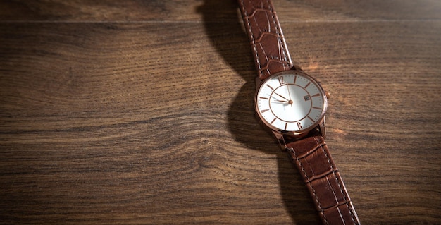 Wristwatch on the wooden background