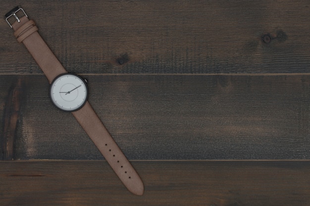 wristwatch on wooden table with free text space