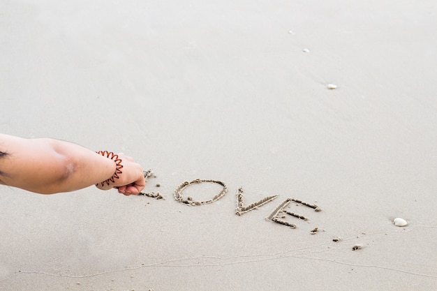 Write the word love letters on the sand