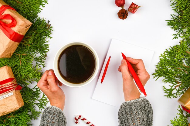 Writes wishes with a coffee mug