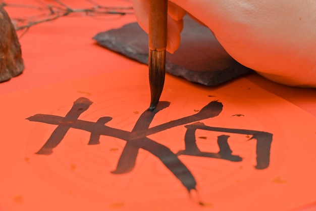 Photo writing chinese calligraphy with word meaning luck for lunar new year