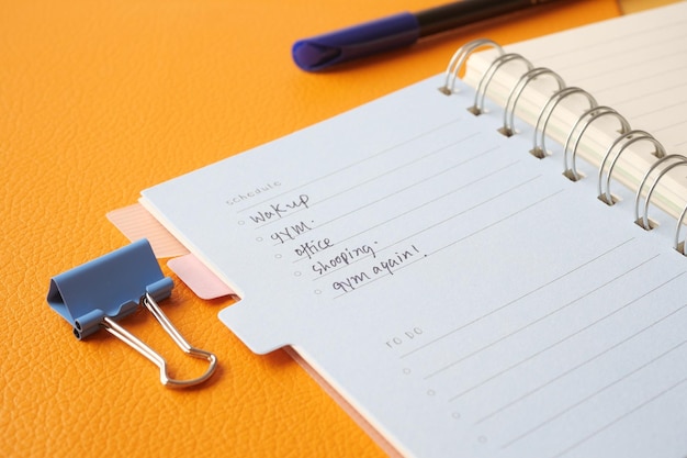 Writing on a daily planner on table