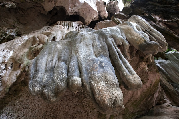 Writing on stone in cave by unconscious human.