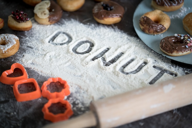 Written letters of dough ready for donut