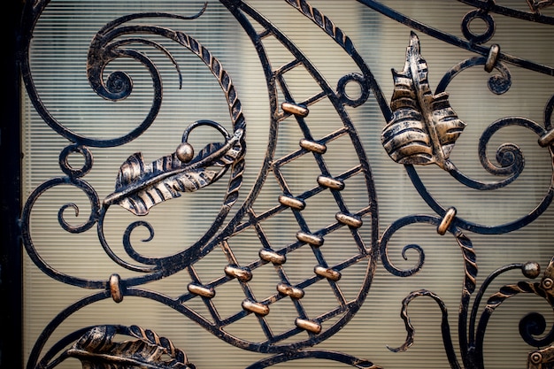 Photo wrought-iron gates, ornamental forging, forged elements close-up.