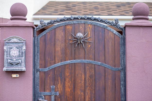 A wrought iron spider decorates the gate. Halloween home decor
