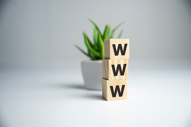 WWW word letter on wooden cubic with copy space. Internet website concept.