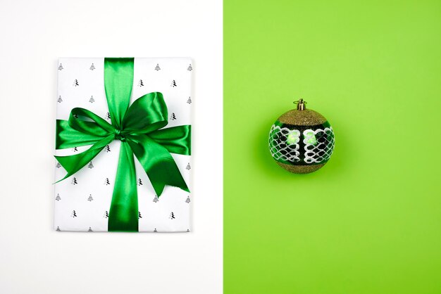 X-mas gift wrapped in paper with Christmas prints and tied with black ribbon. Christmas present box