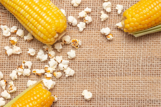 XABrazilian party snacks with corn and popcorn on straw background