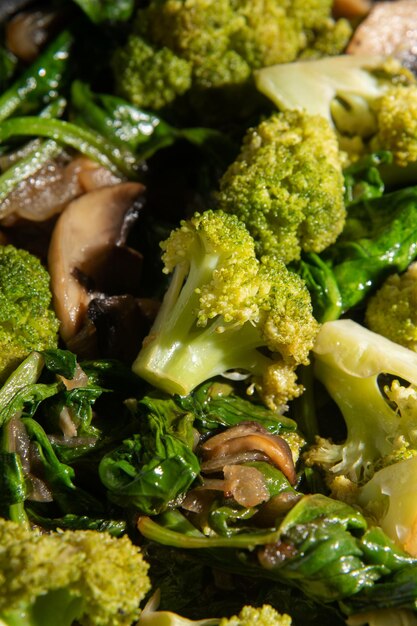 XADish Fried vegetables with mushrooms Broccoli spinach onion Closeup