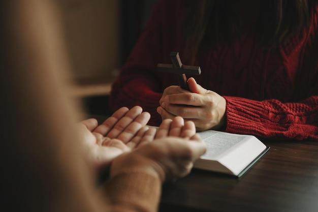 XATwo people reading and study bible in home and pray togetherStudying the Word Of God