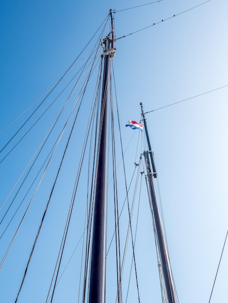 Photo xebec or spar of yacht with clear blue sky, for background