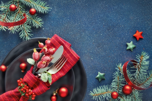 Xmas decorations in red and blue, including spoon and fork in decorated napkin 