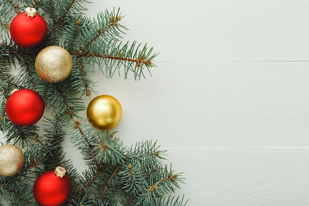 Xmas New Year 2020 holiday celebration pattern composition made of red present gift boxes, fir branches, balls on white wooden background.Concept Christmas time, winter. Flat lay, top view,copy space.