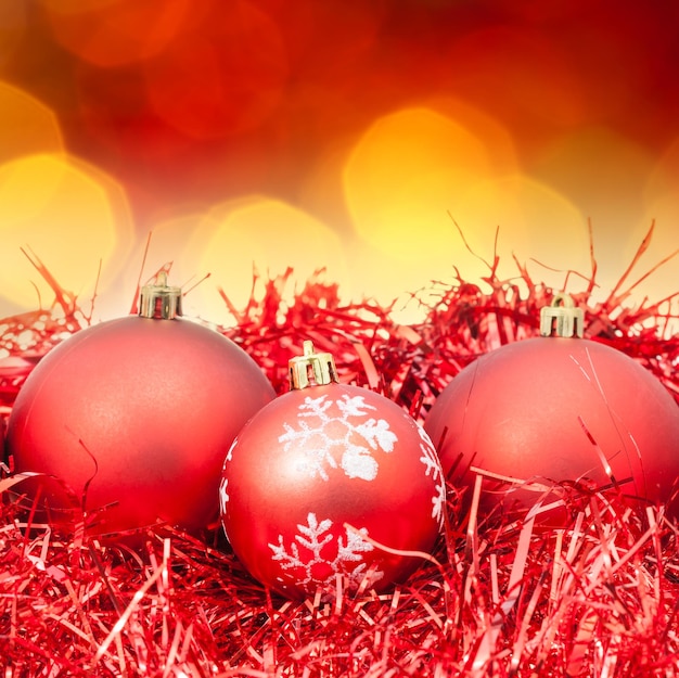 Xmas red balls on blurred red yellow background