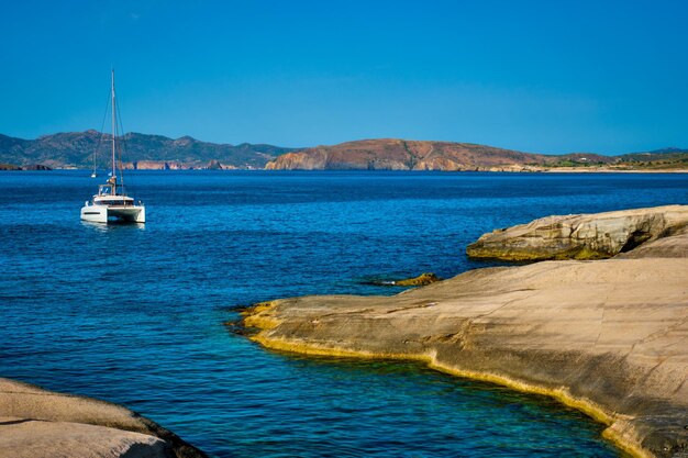 Yacht boat at Sarakiniko Beach in Aegean sea Milos island Greece