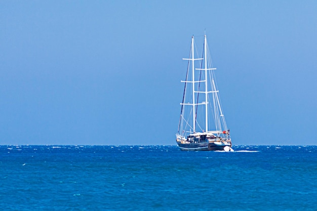 Yacht sails on the blue sea.