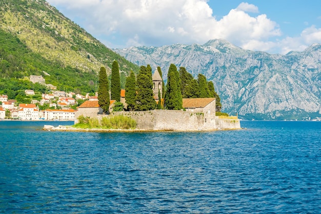 The yacht sails near the picturesque island of St George in the Bay of Kotor