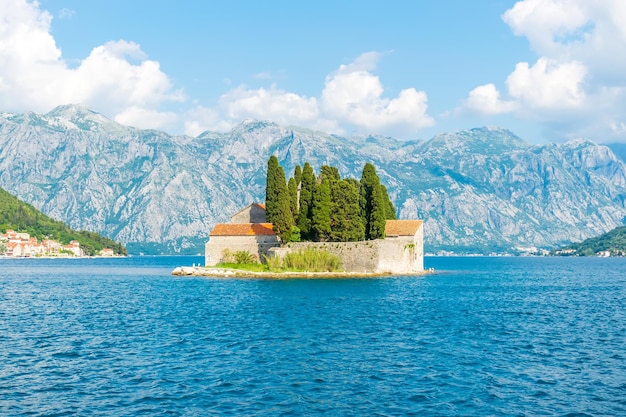 The yacht sails near the picturesque island of St George in the Bay of Kotor