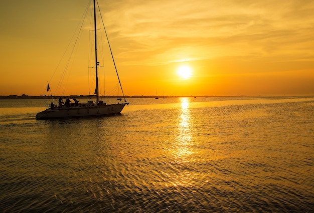 The yacht sails to the pier sea sunset time