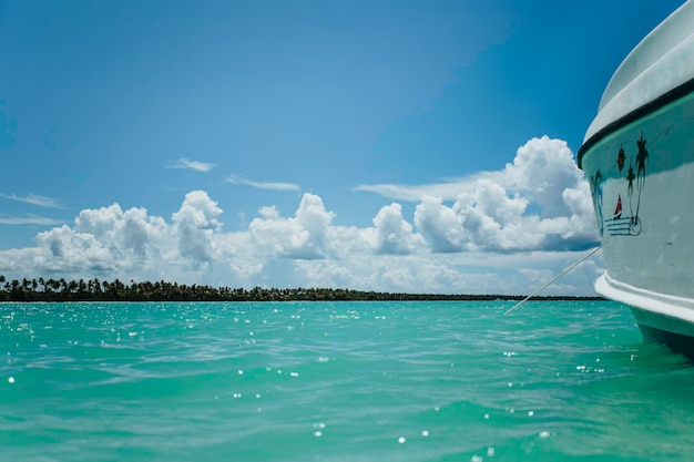 Yacht in sea against cloudy blue sky