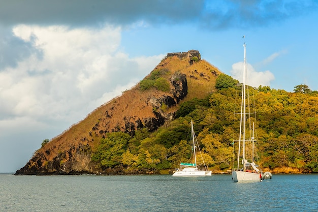 Yachts anchored at the pigeon island with fort ruin on the rock rodney bay saint lucia caribbean sea