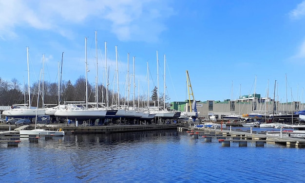 Yachts are waiting for the summer at the yacht club on the shore